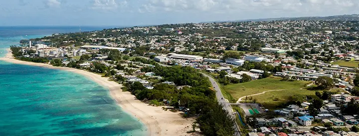 Aerial coastal view in Barbados featuring beach and town.